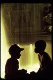 Silhouettes of two children looking at each other