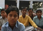 Multiple children looking at camera