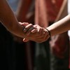 People with their hands joined in prayer