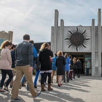 Line of people entering a church