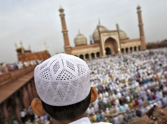 Man wearing a Topi in front of Jama Masjid