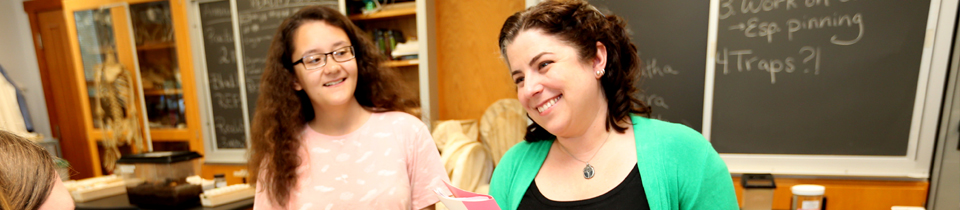 Smiling teachers and students in a classroom