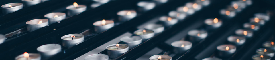 A shelf full of lit candles.