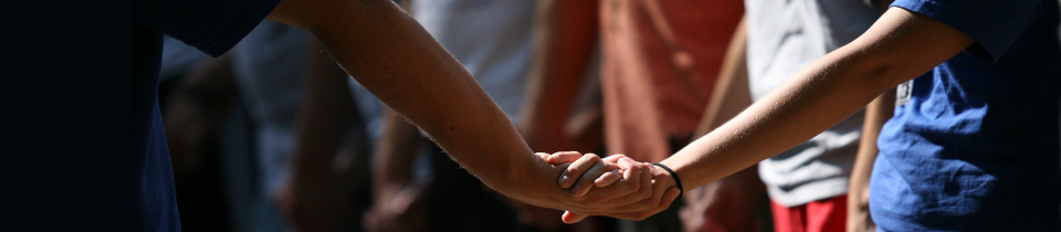 Two people holding hands in a group circle