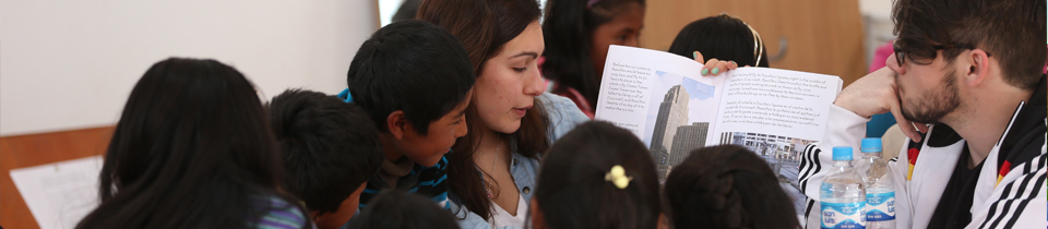 Professor showing and explaining book to other students