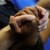 People holding hands in communal prayer