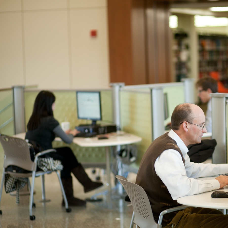 People sitting and looking at computers