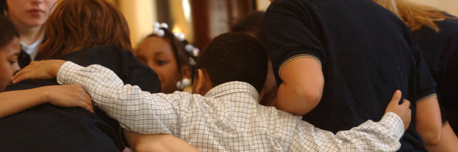 A group of people hugging in a circle