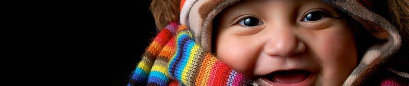 a cute baby in a hat and scarf