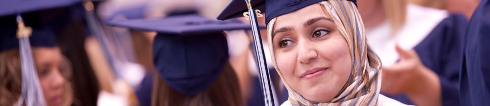 Graduate smiling in graduation ceremony