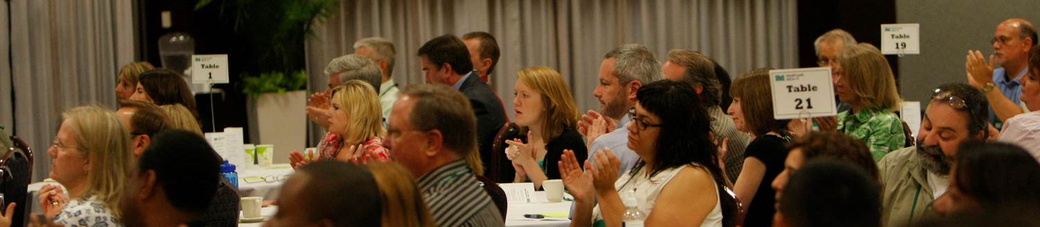 People clapping for a speaker at a banquet held at Xavier University