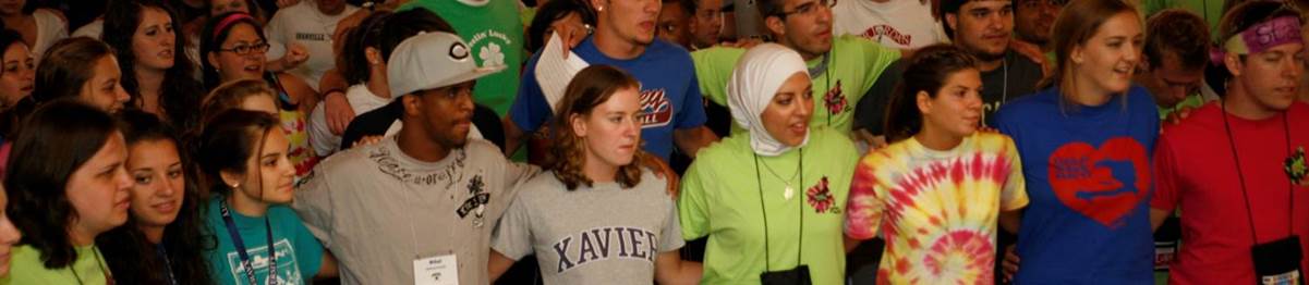 Xavier University students standing with their arms around each other at a retreat