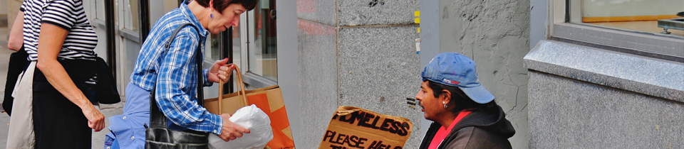 Woman giving food to a homeless man