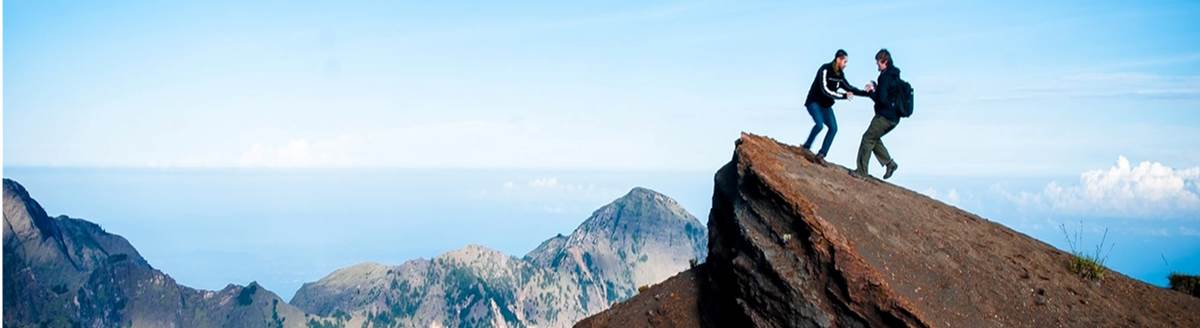 Photo of Students Climbing on a Mountain