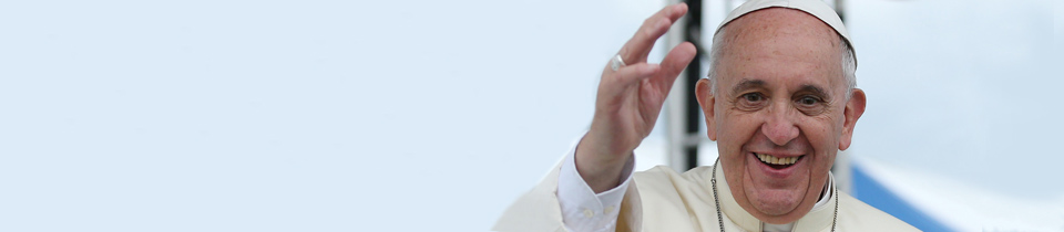 Pope Francis smiling and raising his hand