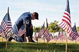 Soldier kneeling at graves