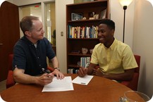 Professor and student working together at a desk