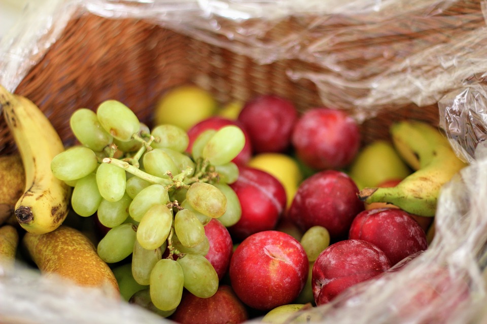 Basket of bananas, grapes, and apples