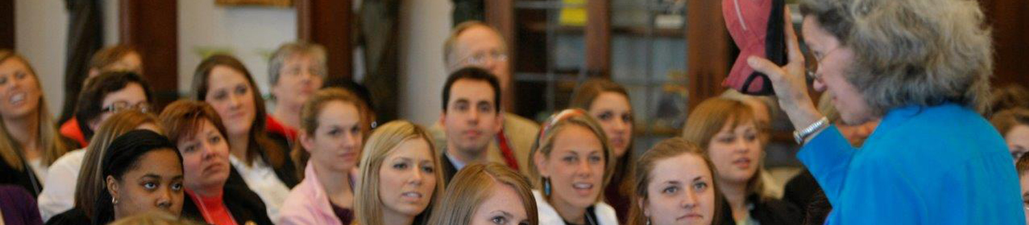 Photo of a presenter lecturing to her audience