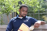 Person reading a book outside