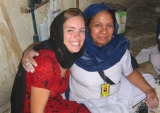 Two people wearing head scarves smiling