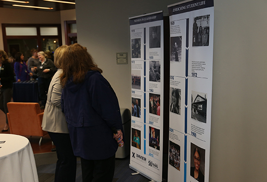 Faculty members looking at books, readings, and other archives at a special event photo