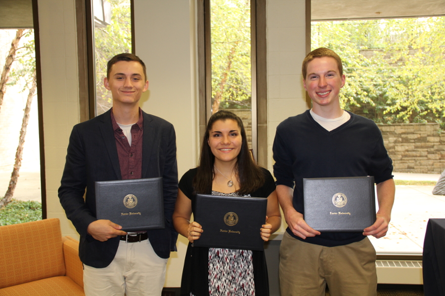 Pat Tilden, Angela Provenzano, and Eric Egan smiling together as they hold their awards