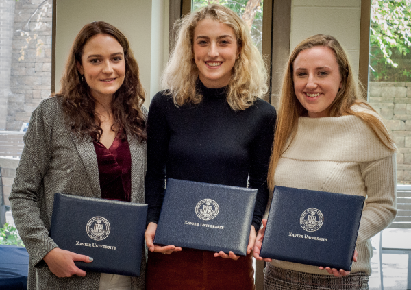 Adams Freeman, Sarah Dempsey, and Aileen Romano holding their awards and smiling together