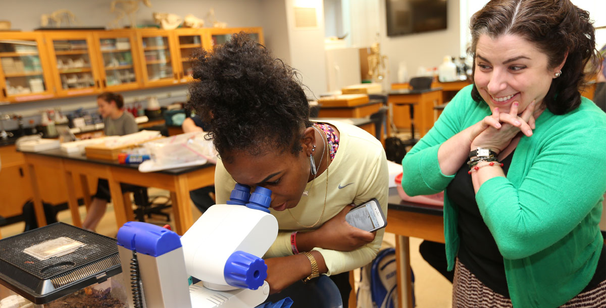 Photo of XU Student and Professor working on a Lab