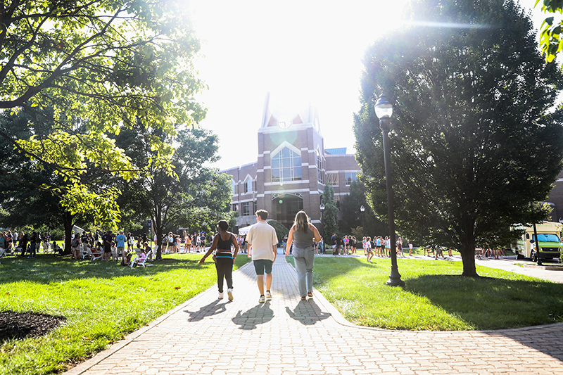 Three Xavier student walk together toward the entrance of the Gallagher Student Center on a summer afternoon