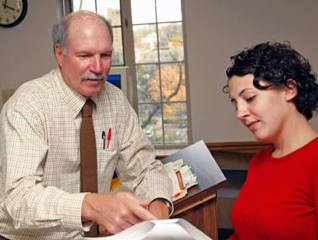 Professor in the master of organizational psychology program interacting with a student in a classroom