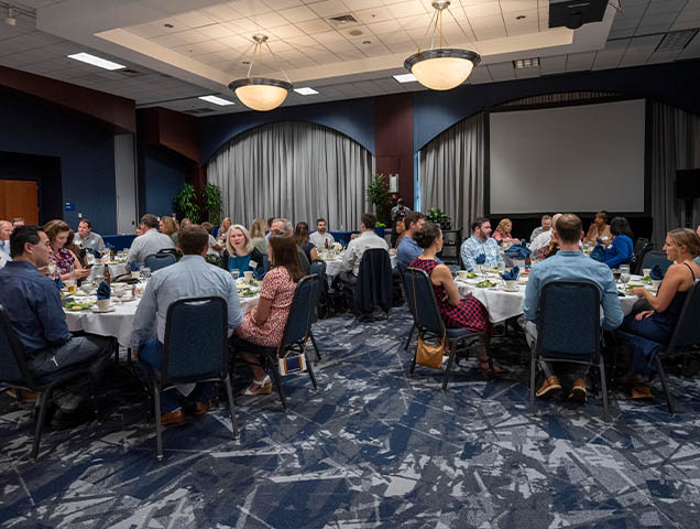 Students eating dinner at the EMBA graduation 