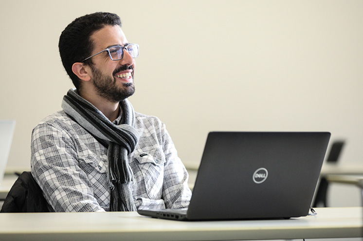 Student sitting at a desk with a laptop