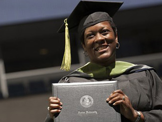 A Xavier student holding a physical copy of their degree during a commencement ceremony