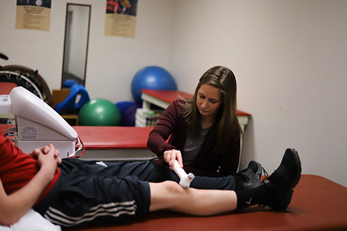 Photo of Cara Carrelli helping an Athlete