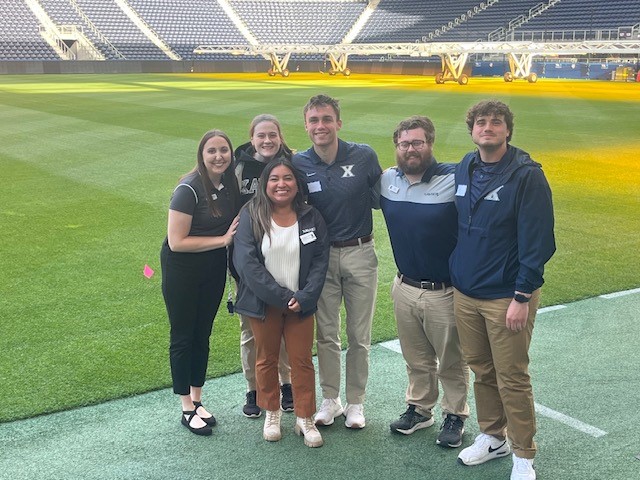 Crista Rosborogh, Xavier Clinicial Education Coordinator & MSAT Students at the TQL Stadium.