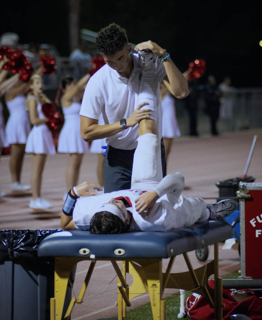 Photo of Jacob Verket helping an athlete