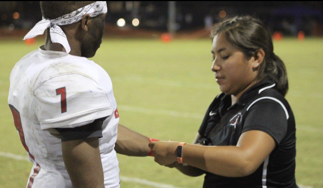 Photo of Crista Rosborough with a Football player