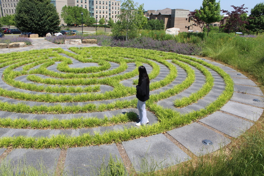Student walking on the Outdoor Labyrinth