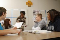 Students and professors having a discussion in a classroom