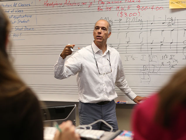 Photo of Professor Instructing Students in a Classroom