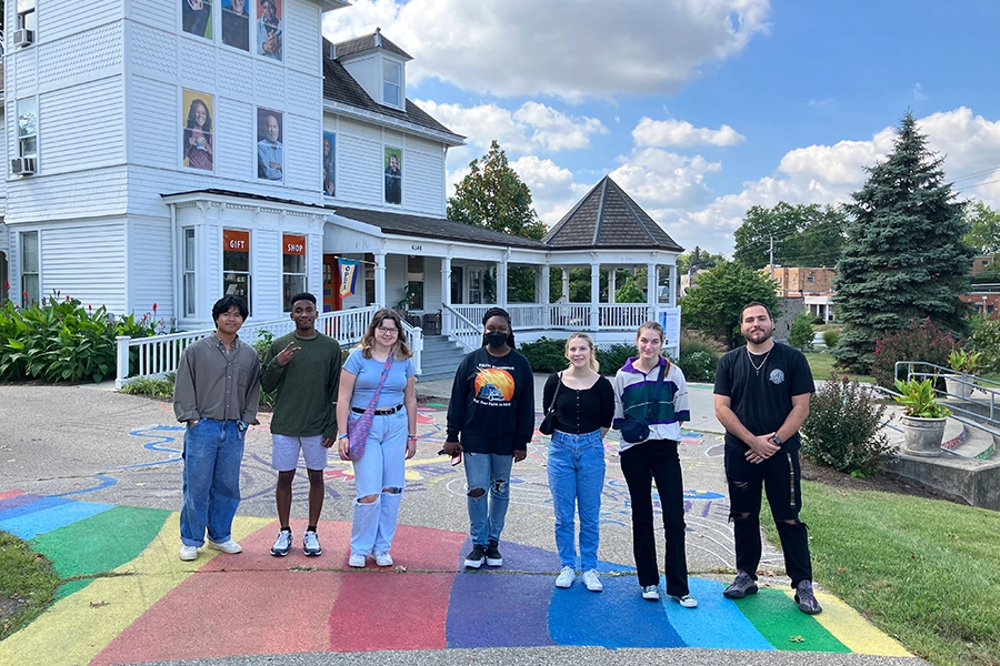 Seven students standing in front of a non-profit headquarters