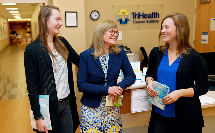 Photo of Student Interns talking with Professional Advisor inside a TriHealth building
