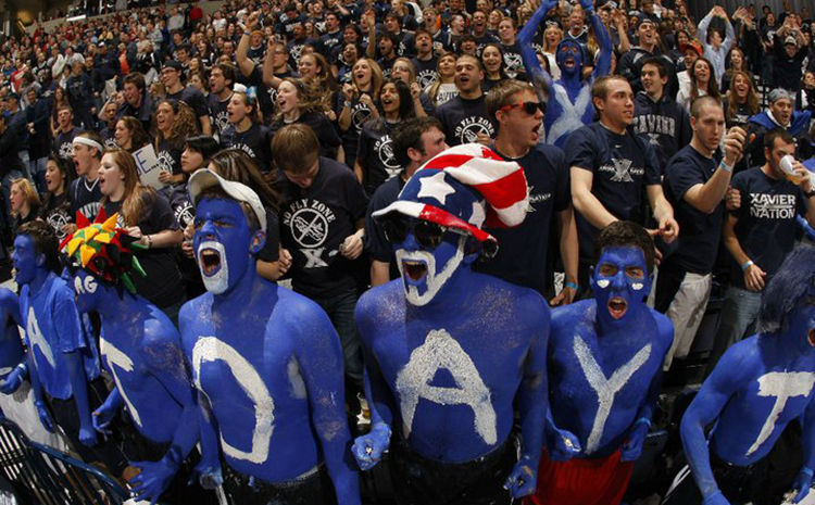 Xavier fans at the Crosstown shootout cheering for their team