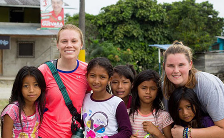 Group Photo of XU Student Volunteers with children