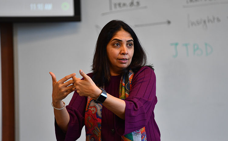 Photo of Rashmi Assudani teaching during a lecture