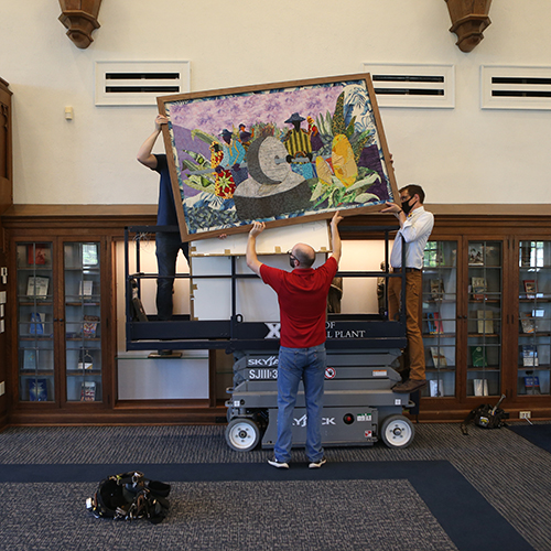 Photo of People putting up Artwork