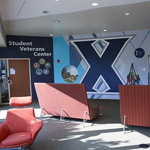 The Student Veteran Center lobby with a large X on the wall and lobby seating.