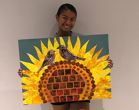 Mio Kamioka holds a sunflower painting