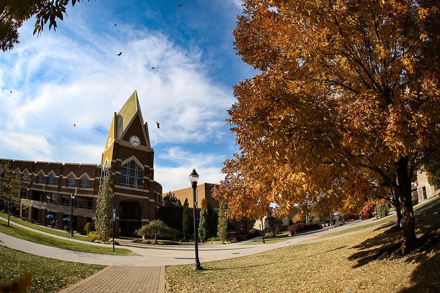 Exterior of Gallagher Student Center on a fall day. The leaves on the trees surrounding Gallagher are brown, orange and red.